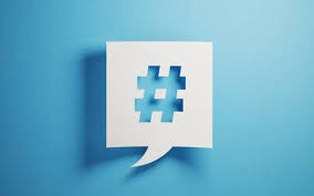 white piece of paper with a hashtag shape cut out of it, laying on a blue surface